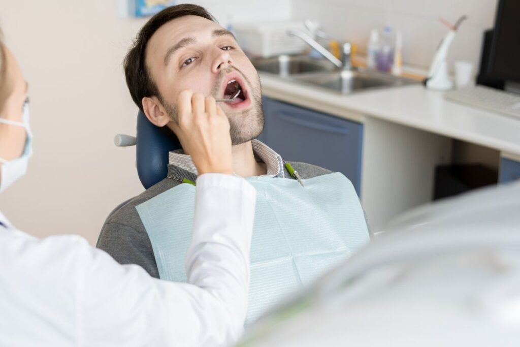 Dentist examining patient's teeth.