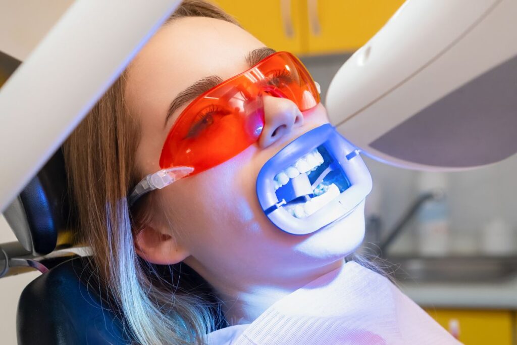 Patient receiving professional teeth whitening treatment.