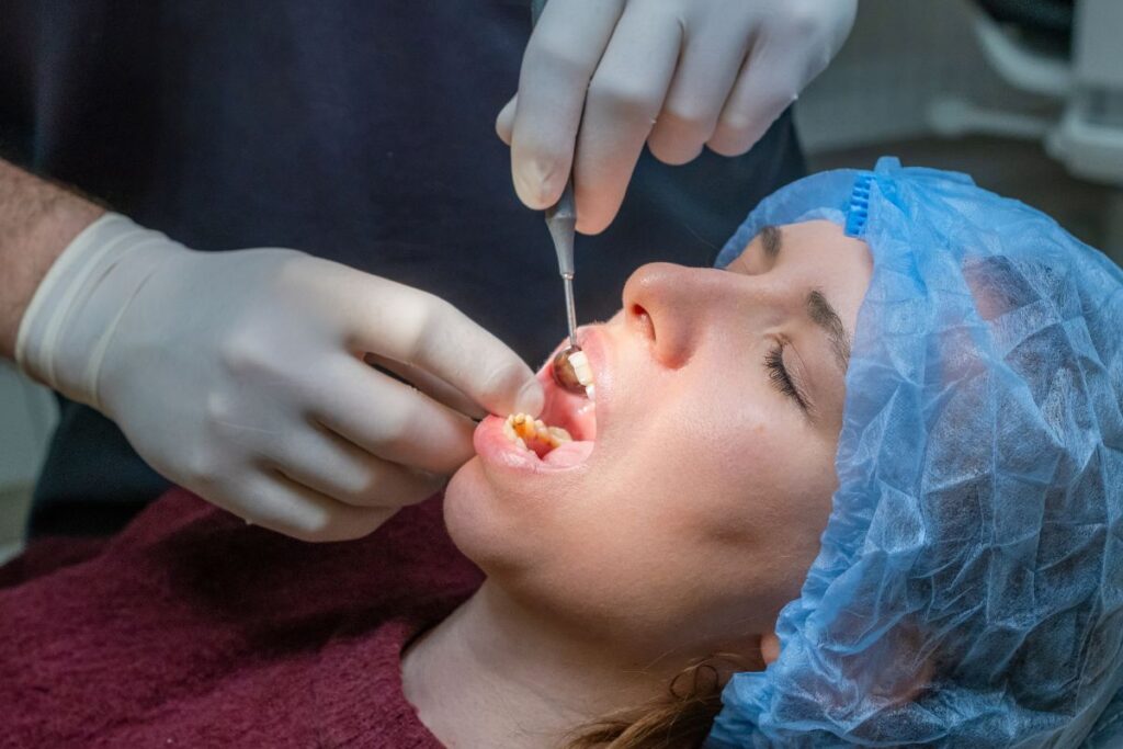 Dentist treating a patient with a severe tooth infection during an emergency dental visit.