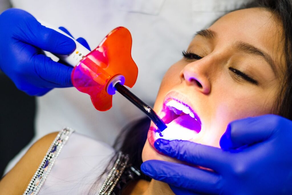 Patient receiving professional in-office teeth whitening treatment.